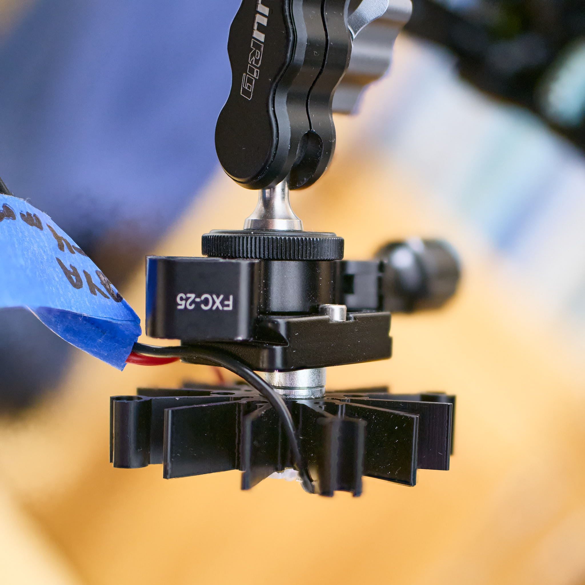 B: The mating of the magnet in the "magic arm" clamp and the attachment point at the back of the heat sink seen from the side.