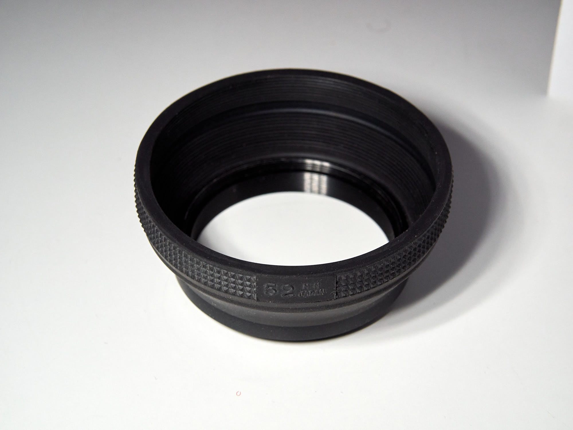 Collapsible rubber lens hood, extended.